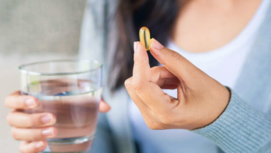 woman holding pill supplement glass water.webp